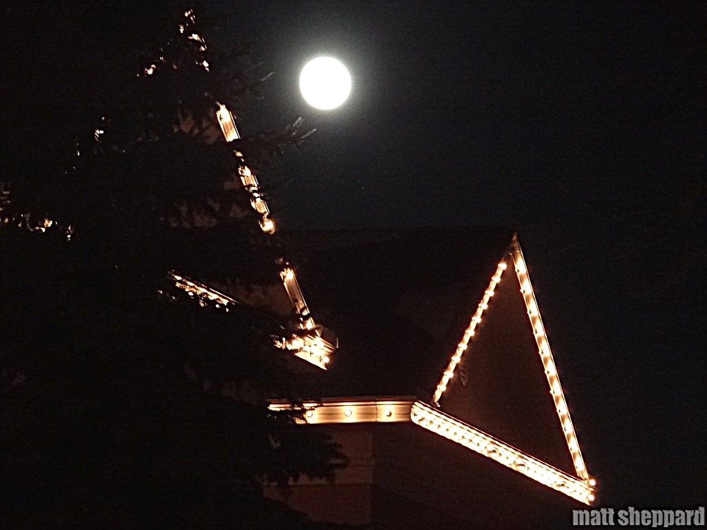 Moon-rise over the Library during the parade. More photos by Matt Sheppard at Facebook
